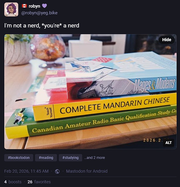 Screenshot of the linked mastodon post, showing a stack of three books.